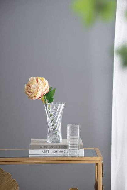 Clear Glass Curved Column Vase 20Cmh. Spiral Pattern That Easily Complements Arrangements Of Foliage And Flowers